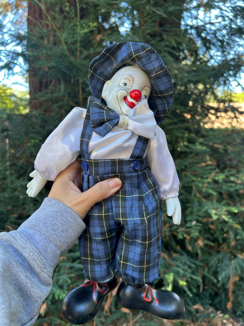 vintage porcelain-faced clown doll wearing a blue plaid outfit figurine decor
